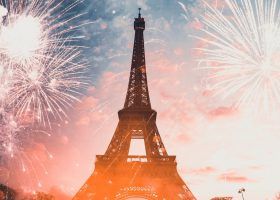 Fireworks blasting next to the Eiffel tower in Paris.