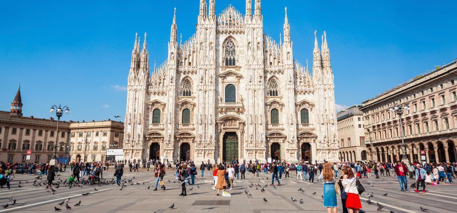 People standing in the plaza of the Milan Duomo.